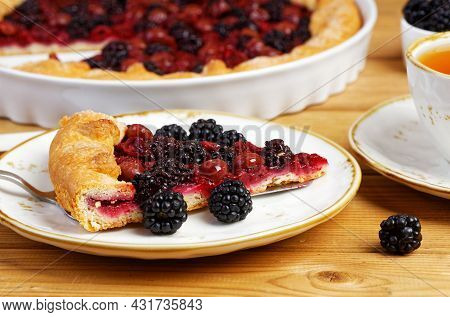 Closeup Piece Of Homemade Open Pie Gallet With Raspberries, Blackberry And Grapes. Shallow Focus.