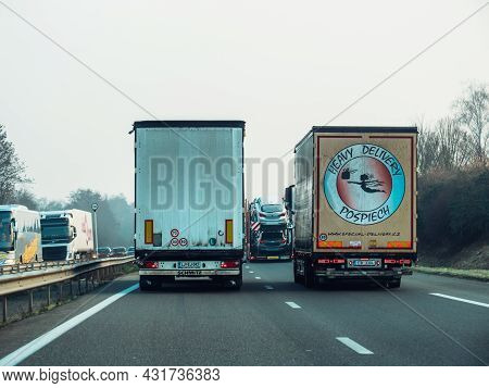 France - Feb 8, 2018: Rear View Of Long Cargo Trucks On French Highways