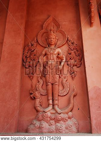 Temple Of Red Color In Thailand. The Facade Of The Temple Is Decorated With Figures Of Dragons And G