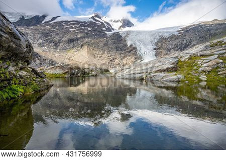 Mountain Glacier In Alpine Valley Reflected In Water. Schlaten Glacier, German: Schlatenkees, Hohe T