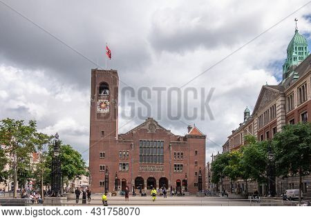 Amsterdam, Netherlands - August 14, 2021: The 2 Red Stone Buildings Of Stock Exchange, One With Cloc