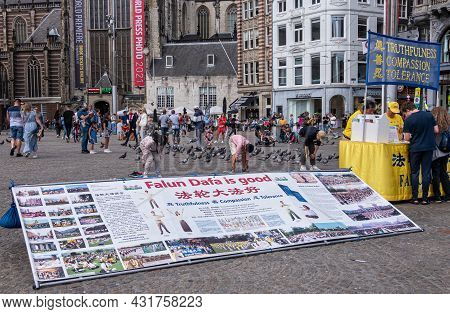 Amsterdam, Netherlands - August 14, 2021: Falun Dafa Info Booth Distributes Flyers And Signatures Ag