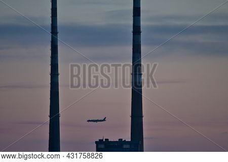 Beautiful Creative Early Morning View Of Airplane Passing Between Two Iconic Poolbeg Ccgt Chimneys S