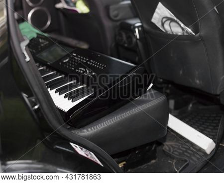 A Synthesizer On A Backseat Of A Messy Car, Shallow Dof