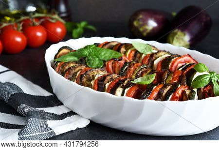 Vegetable Ratatouille On A Black Concrete Background.
Baked Vegetables On The Kitchen Table.