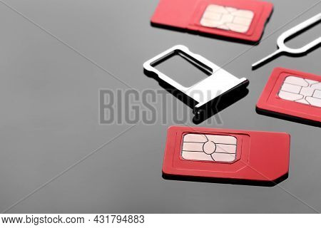 Sim Cards, Tray And Ejector On Grey Background. Space For Text
