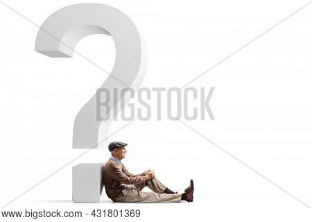 Elderly man sitting on the floor and leaning on a big question mark isolated on white background
