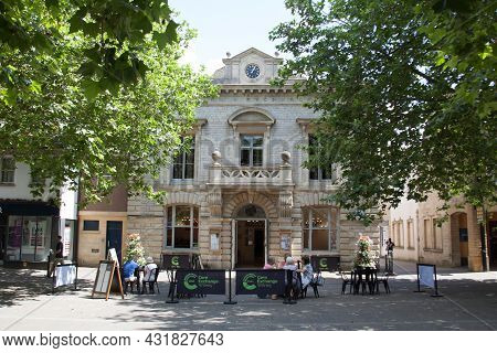 People Sat Outside The Corn Exchange Building In Witney, Oxfordshire In The Uk, Taken 19th July 2021