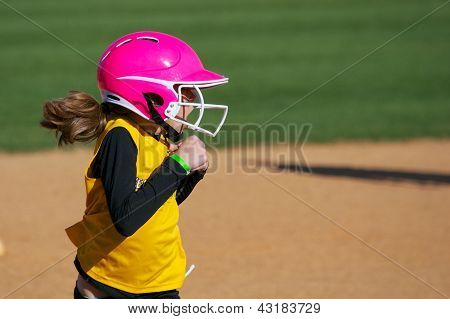 垒球运动员在她脸上惊讶的表情与运行