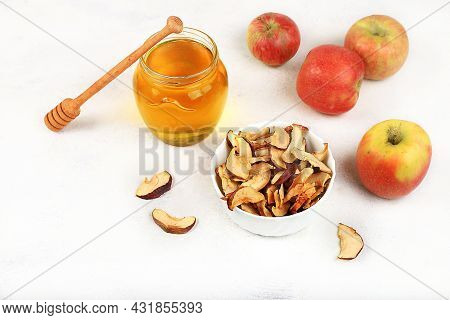 Homemade Apple Chips In A Cup With Apples And Honey On A White Background, In Autumn Apples Are Bake