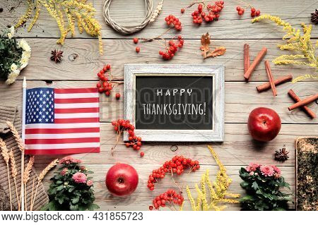Thanksgiving Decorations With Usa Flag. Orange Hokkaido Pumpkins, Rowan Berry, Apples, Good Book And