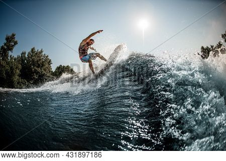 Beautiful View Of The Great Splashing Wave And Man Balanced On It On Foilboard
