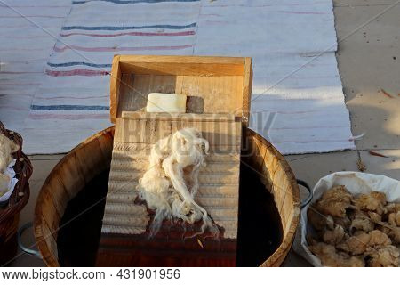 A Wooden Washboard, A Bar Of Soap And Sheep's Wool In A Wooden Basin Of Water. Hand Washing Clothing