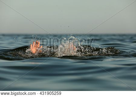 Drowning Man Reaching For Help In Sea