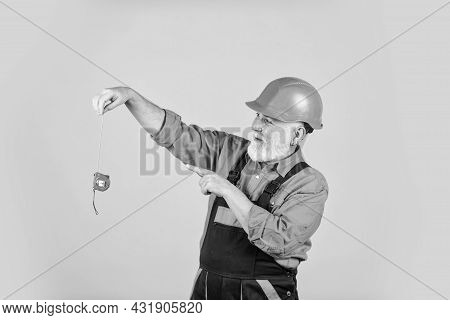 Man At Work. Construction Man Hold Measuring Tape. Engineering And Repair. Happy Carpenter. Handyman