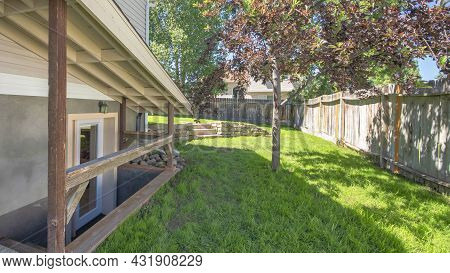 Pano Separate Basement Apartment Entrance With Stairs, Glass Panel And Trees On The Lawn At The Side