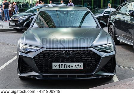 Audi A6 C8 2020 Model In Black Matte Color, Stands On Parking Slot. Frontal View. Modern Building Fa
