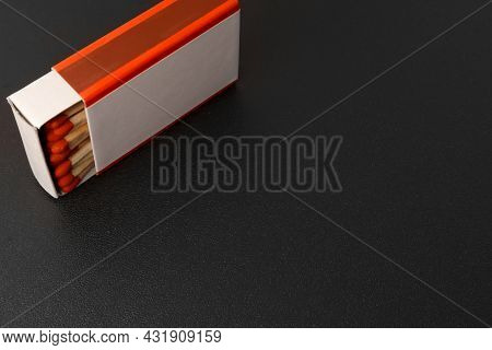 Open Matchbox With A Blank White Label On A Black Background With Free Space.