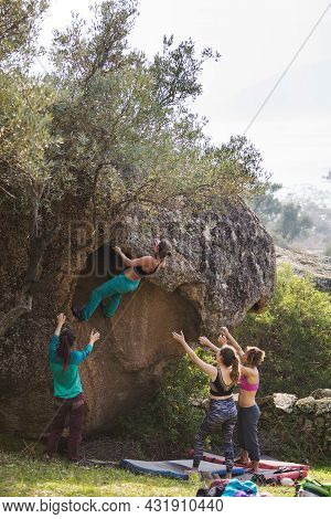 Friends Go In For Sports In Nature, Bouldering On Rocks, Girl Climbs A Big Stone, Woman Is Belayng P