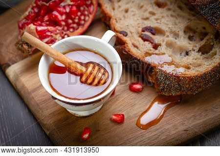 Honey, Pomegranate, And Bread Close-up. Traditional Food For The Celebration Of The Jewish New Year,