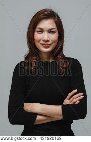 Cute Beautuful Woman In Black Long Sleeves T-shirt Foled Arms And Looking To Camera With Self-confid