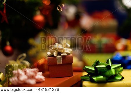 Pile Of Shiny Luxury Colorful Gift Boxes. Christmas And New Year Celebrate Gifts Stack Beside Full D