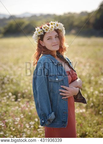 Red-haired Woman On Field On Summer Evening