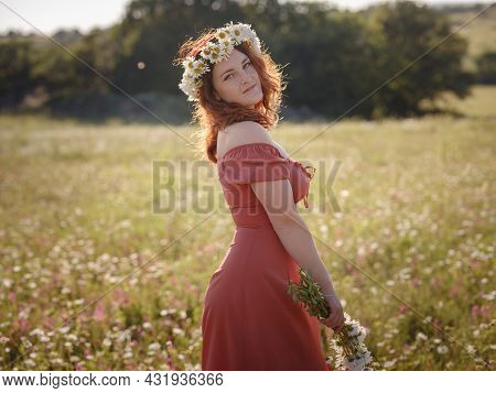 Red-haired Woman On A Field On A Summer Evening