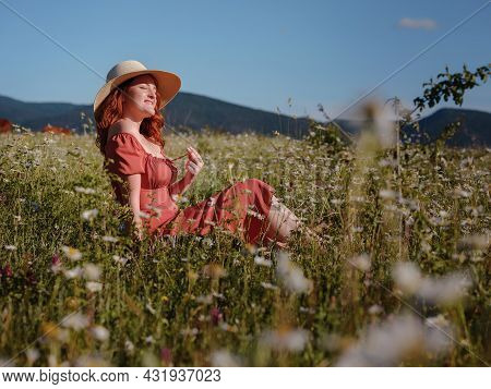 Red-haired Woman On Field Summer Evening