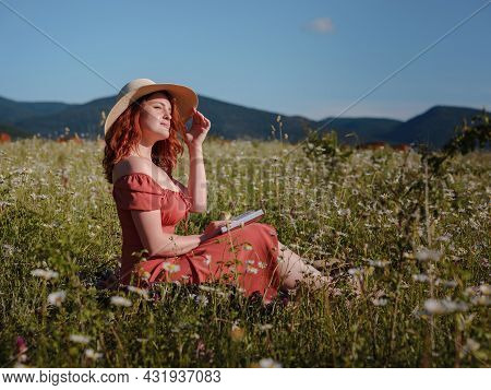 Red-haired Woman On Field Summer Evening