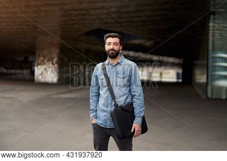 Millennial Businessman With Beard Outdoors Looks At The Camera Serious With Intense Gaze. Portrait O