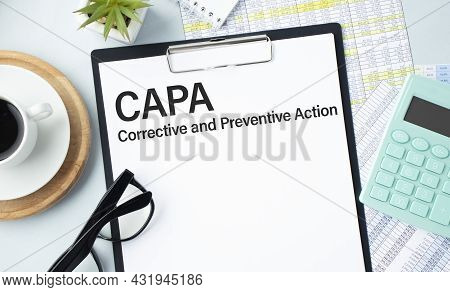 Paper With Text Capa Corrective And Preventive Action On A Table