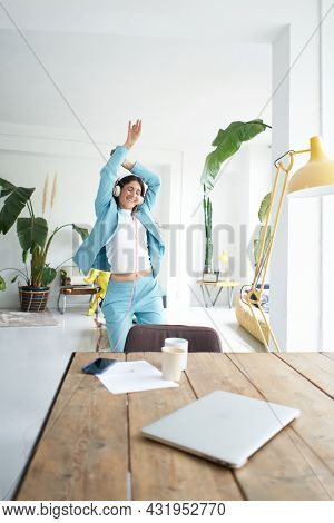 Successful Latina Businesswoman Dances In Office Attire Happily Celebrating At Work. Female Office W