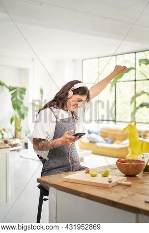 Joyful Young Winner At Home Celebrating The Concept Of Mobile Victory. Euphoric Student Receiving Sm
