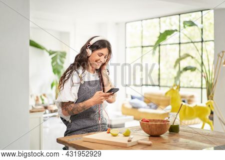 Beautiful Young Woman Listening To Music With Headphones At Home In The Morning Having A Healthy Bre