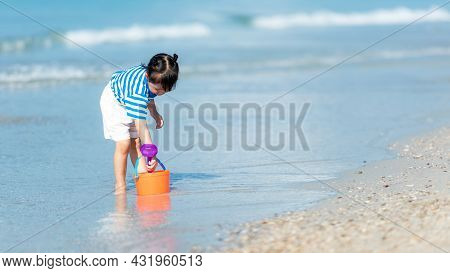 Kid Girl Have Fun And Playing Sand And Water At Tropical Beach. Family Child Tourism Travel Enjoy An