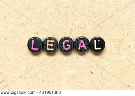 Black Color Round Bead In Word Legal On Wood Background