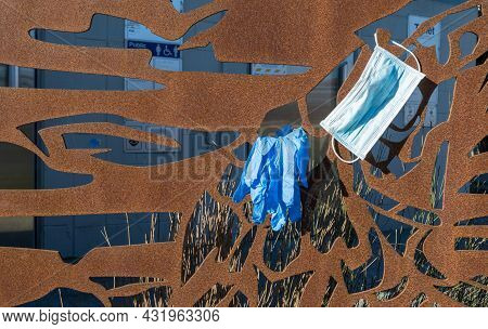 Gloves And Mask Are Left Hang On Some Public Art Work At Petone.