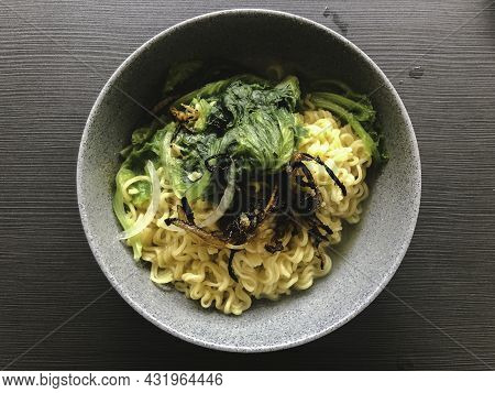 Tasty Instant Noodles With Vegetables In Bowl On Table Close-up