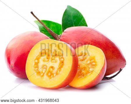 Ripe tamarillo fruits with slices and tamarillo leaves isolated on a white background.