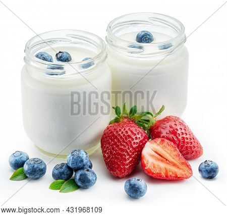 Two glass containers with plain yoghurt and berries isolated on white background.