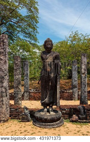 Stainding Buddha statue in ancient ruins. So-called Quadrangle, ancient city Polonnaruwa - famous tourist attraction, Sri Lanka