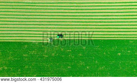 Above Top View On Tractor As Pulling Grass Cutting Machinery Over Field Of Clover, Cutting Alfalfa I