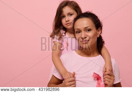 Woman And Girl In Pink Attire With Breast Cancer Awareness Ribbon, Daughter Hugging Her Mother, Hold