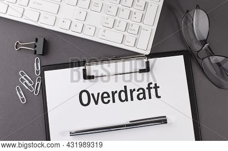 Office Paper Sheet With Text Overdraft And Keyboard. Business