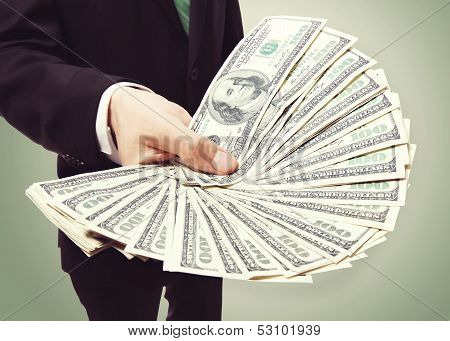 Business Man Displaying A Spread Of Cash