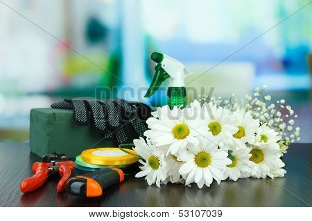 Composition with florist tools on table on bright background