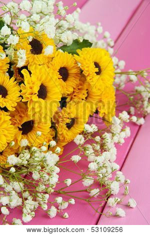 Beautiful flowers on wooden background