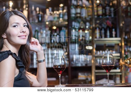 Beautiful Woman Seated At A Bar Counter