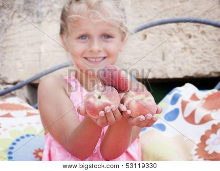 Girl Holding Out Peaches